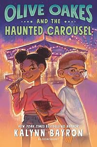 Book cover for Olive Oakes and the Haunted Carousel. A young girl with brown skin and black hair pulled into 2 puffy pigtails smiles with a notebook under one arm and a pen in the other hand. A younger boy with light brown skin, red hair and glasses smiles next to her. A carousel is lit up behind them.