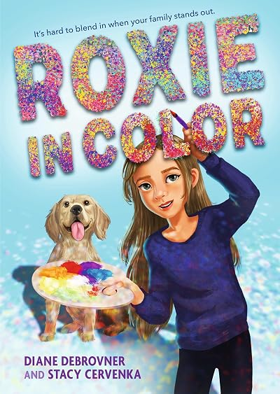 Cover art for Roxie In Color. A girl with long brown hair smiles holding a paint brush in one hand and a palette with many colors of paint in the other. A yellow lab sits behind her with its tongue hanging out. 
